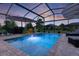 Enclosed screened pool area offers comfortable seating, string lights, and a relaxing atmosphere for entertaining or enjoying the outdoors at 3641 Arlington Ridge Blvd, Leesburg, FL 34748