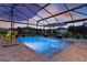 Beautiful screened-in pool featuring umbrellas, patio seating, and ambient lighting, creating an ideal space for outdoor relaxation at 3641 Arlington Ridge Blvd, Leesburg, FL 34748