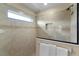 Walk-in shower with neutral-colored tiling and a glass partition at 3641 Arlington Ridge Blvd, Leesburg, FL 34748