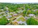 Neighborhood shot showing home amidst lush foliage with glimpses of a tranquil waterfront in the distance at 375 N Boyd St, Winter Garden, FL 34787
