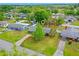 Aerial view of a well-maintained home featuring a green lawn and a paved driveway at 375 N Boyd St, Winter Garden, FL 34787