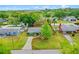 Aerial view of a quaint home with well-maintained landscaping, a long driveway, and bordered by lush trees at 375 N Boyd St, Winter Garden, FL 34787