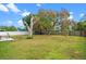 Expansive backyard with lush green grass, mature trees, a fence, and a storage shed at 375 N Boyd St, Winter Garden, FL 34787