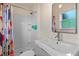 Bathroom featuring a sink with a large mirror and a tub/shower with white tile at 375 N Boyd St, Winter Garden, FL 34787