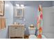 Cozy bathroom featuring a vanity with a marble countertop, a toilet and a shower/tub combo at 375 N Boyd St, Winter Garden, FL 34787