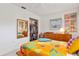 Bright bedroom with a wood frame bed, dresser, a large mirror, closet and a window offering natural light at 375 N Boyd St, Winter Garden, FL 34787