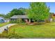 Charming single-story home featuring a lush lawn, beautiful landscaping, and cozy seating area at 375 N Boyd St, Winter Garden, FL 34787