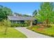 Charming single-story home with well-maintained landscaping, vibrant plantings, and a cozy front porch area at 375 N Boyd St, Winter Garden, FL 34787