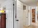 Hallway with view to white tiled bathroom, closet and hallway book shelf at 375 N Boyd St, Winter Garden, FL 34787