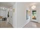 Bright hallway with terrazzo flooring, white walls, and a view of the front yard through the glass door at 375 N Boyd St, Winter Garden, FL 34787