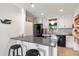 Kitchen area with bar seating and updated appliances and marble backsplash at 375 N Boyd St, Winter Garden, FL 34787