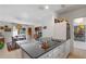 Bright kitchen with a large island with a gray countertop, white cabinets, and stainless steel appliances at 375 N Boyd St, Winter Garden, FL 34787