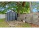 Well-maintained storage shed with a fenced-in area and mature tree providing shade at 375 N Boyd St, Winter Garden, FL 34787