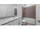 Bathroom features modern vanity with granite countertop and decorative tile surround at 40700 E Ninth Ave, Umatilla, FL 32784