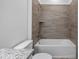 Clean bathroom with granite countertop, decorative tile surround, and bath tub at 40700 E Ninth Ave, Umatilla, FL 32784