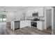 The kitchen features stainless steel appliances, granite countertops, and sleek white cabinetry at 40700 E Ninth Ave, Umatilla, FL 32784