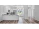 Modern kitchen boasts granite countertops, stainless steel appliances, and white cabinetry at 40700 E Ninth Ave, Umatilla, FL 32784
