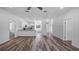 Open living space with a modern kitchen with stainless steel appliances and a large living area at 40700 E Ninth Ave, Umatilla, FL 32784