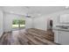 Open-concept living area with sleek flooring, backyard access and kitchen with modern granite countertops at 40700 E Ninth Ave, Umatilla, FL 32784