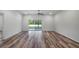 Spacious living area with stylish floors, neutral walls, modern ceiling fan and access to backyard at 40700 E Ninth Ave, Umatilla, FL 32784