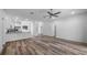 A welcoming living room with vinyl plank floors offering seamless transition to the modern kitchen and dining spaces at 40700 E Ninth Ave, Umatilla, FL 32784