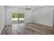 Bright living room with modern flooring and a large sliding glass door to the backyard, with great natural light at 40700 E Ninth Ave, Umatilla, FL 32784