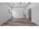 Bright main bedroom with wood-look flooring and walk-in closet access at 40700 E Ninth Ave, Umatilla, FL 32784