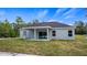 Back of the house showing the porch and backyard featuring a minimalist design with good outdoor light at 40700 E Ninth Ave, Umatilla, FL 32784