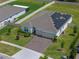 Stunning aerial shot of a home with solar panels, a brick driveway, and a manicured lawn at 4131 Sunset Preserve Blvd, Orlando, FL 32820