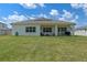 Expansive backyard features a covered patio perfect for relaxing or entertaining outdoors at 4131 Sunset Preserve Blvd, Orlando, FL 32820