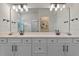 Bright bathroom featuring double vanity, modern fixtures, and a large mirror at 4131 Sunset Preserve Blvd, Orlando, FL 32820