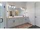 Luxurious bathroom featuring dual vanities, modern lighting, a soaking tub, and a walk-in shower at 4131 Sunset Preserve Blvd, Orlando, FL 32820