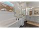 Elegant bathroom featuring a soaking tub, walk-in shower, and dual vanities with modern fixtures at 4131 Sunset Preserve Blvd, Orlando, FL 32820