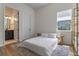 Bright bedroom featuring a minimalist design with ensuite bathroom and natural light at 4131 Sunset Preserve Blvd, Orlando, FL 32820