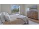 Bedroom with large window providing lots of natural light and wood-look laminate flooring at 4131 Sunset Preserve Blvd, Orlando, FL 32820