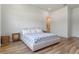 Bright bedroom with hardwood floors, woven nightstands, and a cozy bed for a peaceful ambiance at 4131 Sunset Preserve Blvd, Orlando, FL 32820