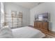Comfortable bedroom featuring stylish shelving, console and bright natural light at 4131 Sunset Preserve Blvd, Orlando, FL 32820