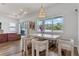 Bright dining area with modern table, chairs, chandelier, and large windows overlooking the backyard at 4131 Sunset Preserve Blvd, Orlando, FL 32820