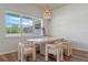 Dining room with modern table and chairs, chandelier lighting, and large windows at 4131 Sunset Preserve Blvd, Orlando, FL 32820