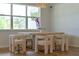 Dining room features large window with lots of light, modern chairs and light fixture at 4131 Sunset Preserve Blvd, Orlando, FL 32820