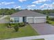 Well maintained home featuring lush landscaping, brick paved driveway and a three car garage at 4131 Sunset Preserve Blvd, Orlando, FL 32820