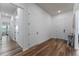 Entryway with wood-look floors, white walls and doors, and views into other rooms at 4131 Sunset Preserve Blvd, Orlando, FL 32820