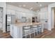Bright kitchen features custom white cabinets, stone countertops, an island, and pendant lighting at 4131 Sunset Preserve Blvd, Orlando, FL 32820