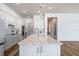 Modern kitchen featuring stainless appliances, marble countertop island with pendant lights, and wood floors at 4131 Sunset Preserve Blvd, Orlando, FL 32820