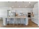 Modern kitchen with a large island, pendant lights, stainless appliances, and white cabinets at 4131 Sunset Preserve Blvd, Orlando, FL 32820