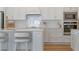 Modern kitchen with white cabinets, herringbone backsplash, quartz countertop, and stainless appliances at 4131 Sunset Preserve Blvd, Orlando, FL 32820