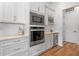Built in microwave and oven with matching white cabinets and countertop at 4131 Sunset Preserve Blvd, Orlando, FL 32820