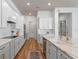 Spacious kitchen with stone countertops, stainless steel appliances, tile backsplash, and wood flooring at 4131 Sunset Preserve Blvd, Orlando, FL 32820