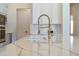 Quartz countertop and goose neck faucet are the main focal points in this kitchen at 4131 Sunset Preserve Blvd, Orlando, FL 32820