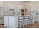Beautiful white kitchen with a large center island, seating and stainless steel appliances at 4131 Sunset Preserve Blvd, Orlando, FL 32820